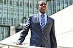 African Businessman Walking Down Stairs Stock Photo