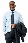 African Smiling Businessman, Hands In Pockets Stock Photo