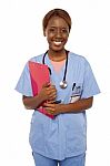 African surgeon holding clipboard Stock Photo