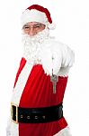 Aged Man In Santa Costume Offering Keys Stock Photo