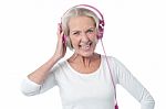 Aged Woman Listening To Music Stock Photo