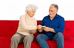 An Old Couple Holding Money Stock Photo