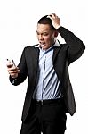 Angry Young Man Using Mobile Stock Photo