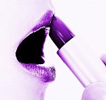 Applying Mauve Or Purple Lipstick Stock Photo