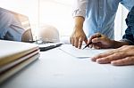 Architects Engineer Discussing At The Table With Blueprint - Clo Stock Photo