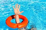 Arm Through Orange Buoy In Swimming Pool Stock Photo