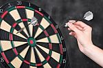Arrow In Hand And Dartboard Stock Photo