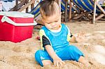 Asian Boy Playing Sand On The Beach Stock Photo