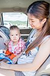 Asian Boy Sitting In The Car With His Mother Stock Photo