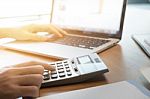 Asian Business Woman Using A Calculator To Calculate The Numbers Stock Photo