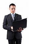 Asian Businessman Holding Laptop Stock Photo