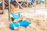 Asian Cute Boy Playing Sand On The Beach Stock Photo