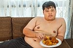 Asian Fat Man Eating Fried Chicken Stock Photo