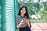 Asian Girl And Computer Tablet In Hand Standing With Toothy Smiling Face Use For People And Internet Connecting ,communication In Modern Digital Lifestyle Stock Photo