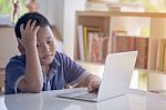 Asian Kid Lose Playing Video Game With Laptop Computer Stock Photo