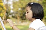 Asian Little Girl Painting In In The Park Stock Photo