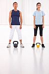 Asian Man And Woman Doing Kettle Bell Crossfit Exercise Stock Photo