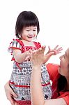 Asian Mother Playing Her Adorable Little Daughter, On White. Studio Shot Stock Photo
