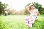 Asian Woman Are Tired Sitting On The Lawn Stock Photo