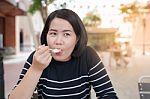 Asian Woman Eating Dessert Stock Photo