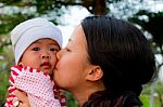 Asian Woman Kissing Her Baby Stock Photo
