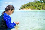 Asian Woman Look At The Clear Water In Their Hands On The Sea Stock Photo