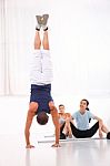 Asian Woman Looking Man Doing Handstand Exercise Stock Photo