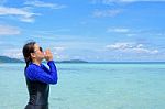 Asian Woman Shouting With Hands On The Sea In Summer, Thailand Stock Photo