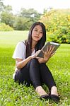 Asian Woman Using Tablet Computer Stock Photo