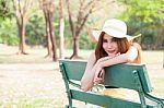 Asian Women Sitting On A Bench In The Park Stock Photo