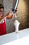 Attractive Girl Pouring Shake In Glass Stock Photo
