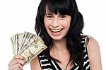 Attractive Young Girl Holding Currency Fan Stock Photo