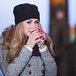 Attractive Young Stylish Blonde Girl Drinks Hot Drink From A Mug Stock Photo