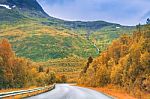 Autumn Road In Mountains Stock Photo