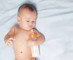 Baby Boy Holding Milk Bottle Stock Photo