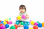 Baby Girl Is Playing Ball On White Background Stock Photo