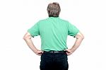 Back Pose Of Elderly Guy With Hands On His Waist Stock Photo