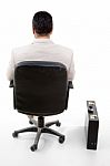 Back Pose Of Male Sitting On Chair Stock Photo