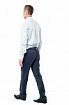 Back View Of Walking Businessman Stock Photo