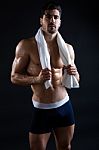 Beautiful And Muscular Man In Dark Background Stock Photo