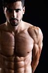 Beautiful And Muscular Man In Dark Background Stock Photo