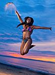 Beautiful Black African American Woman Jumping On The Beach At S Stock Photo