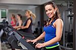 Beautiful Brunette On A Treadmill Stock Photo