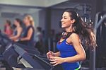 Beautiful Brunette On A Treadmill Stock Photo