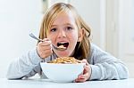 Beautiful Child Having Breakfast At Home Stock Photo