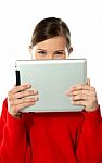 Beautiful Girl Hiding Her Face With Touch Pad Stock Photo