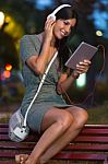 Beautiful Girl Listening To Music In The City At Night Stock Photo