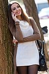 Beautiful Girl Talking On Phone In Autumn Stock Photo