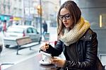 Beautiful Girl Using Her Mobile Phone In Cafe Stock Photo
