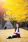 Beautiful Girl With Yellow Leaves In Nami Island, Korea. Nami Island In Autumn Stock Photo